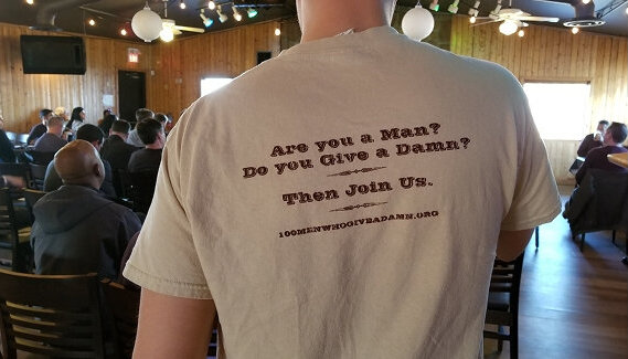Member wearing a t-shirt that says are you a man, do you give a damn, then join us