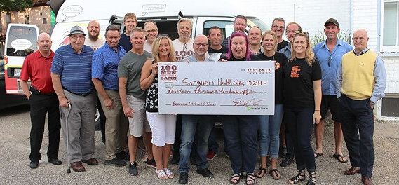 100 Men Who Give a Damn giving a donation to Sanguen